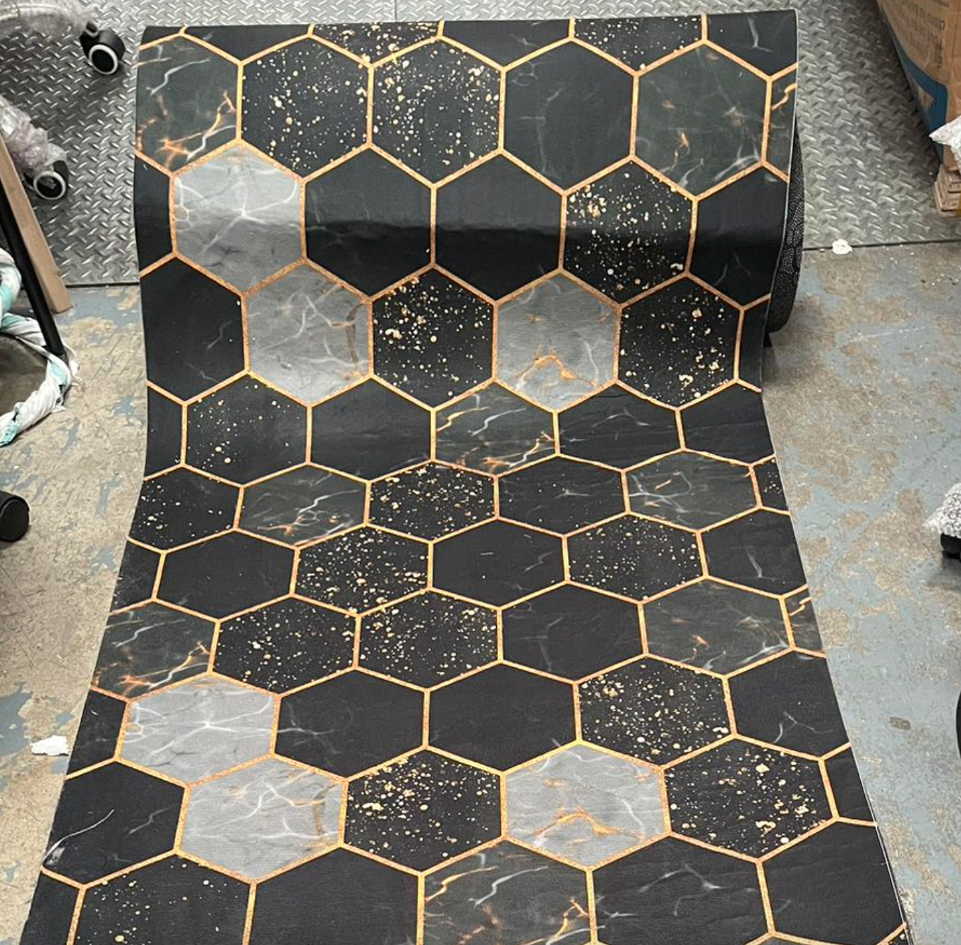 Hexagonal black and gold tiles on a floor